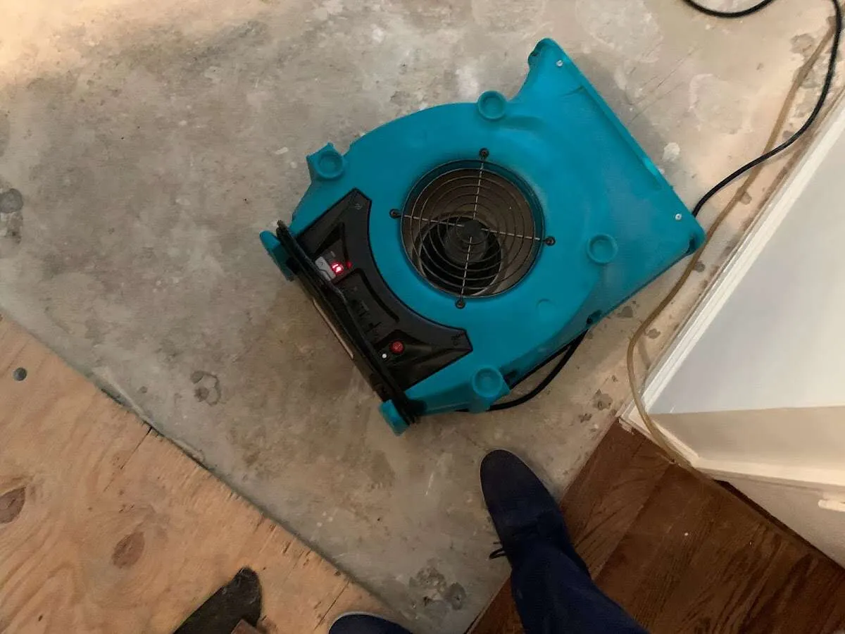 Air mover drying subfloor during Leak Detection & Repair in Cleveland